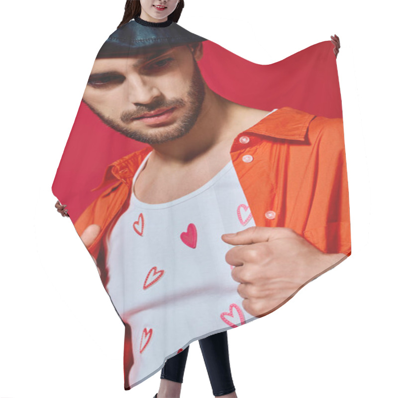 Personality  A Romantic Man Shows Off His Style In A Heart-patterned T-shirt On A Red Backdrop. Hair Cutting Cape