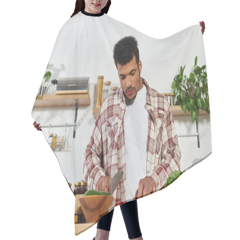 Personality  Handsome Young Man Chopping Vegetables In A Contemporary Kitchen, Focused On Healthy Cooking. Hair Cutting Cape