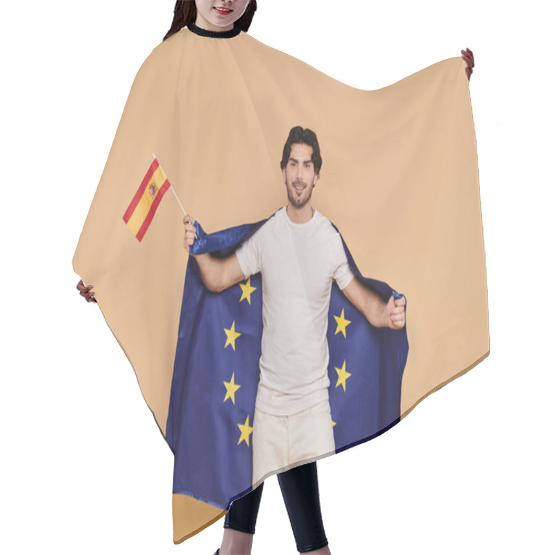 Personality  Handsome Young Man Holds The Spanish Flag While Wrapped In The European Union Flag, Exuding Joy. Hair Cutting Cape