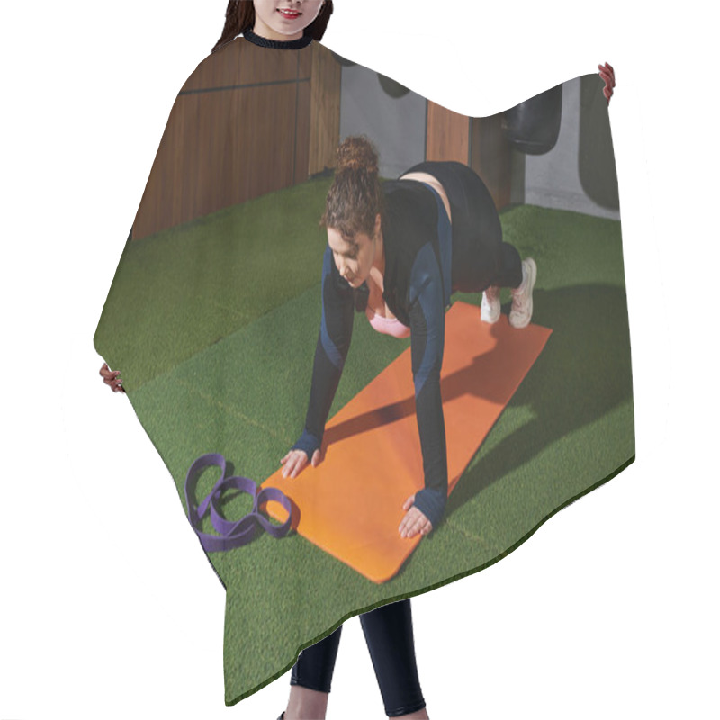 Personality  Dedicated Woman Performs A Challenging Plank Exercise On An Orange Mat In A Gym Setting Hair Cutting Cape