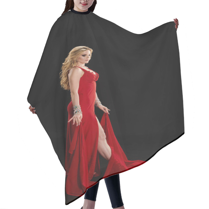 Personality  A Graceful Young Woman In A Vibrant Red Dress Strikes A Pose. Hair Cutting Cape