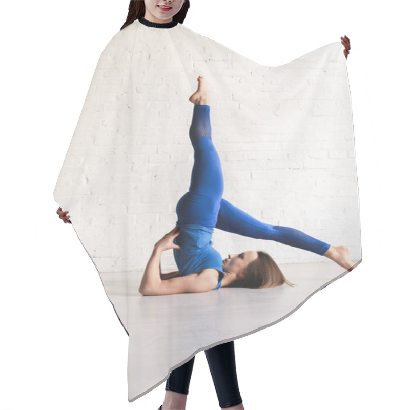 Personality  sportive young woman stretching back while practicing yoga  hair cutting cape