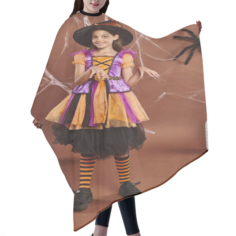 Personality  Cheerful Girl In Witch Hat And Dress Dancing Near Bucket With Sweets On Brown, Halloween Concept Hair Cutting Cape