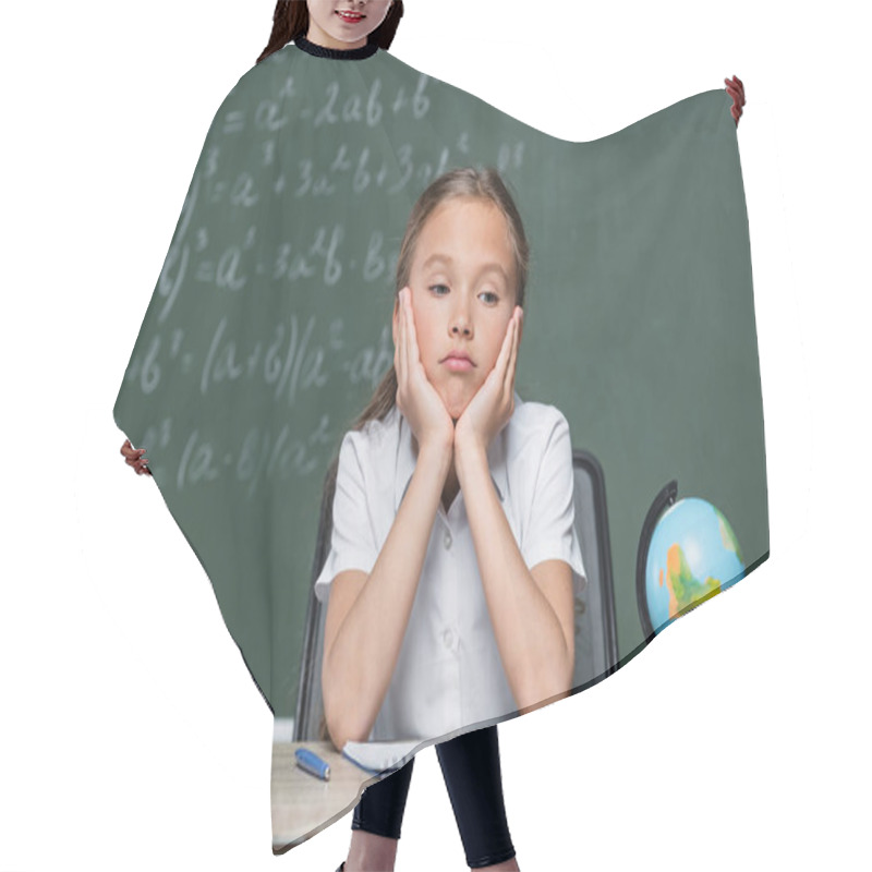 Personality  Upset Schoolkid Sitting At Desk Near Globe, Notebook And Apple Hair Cutting Cape