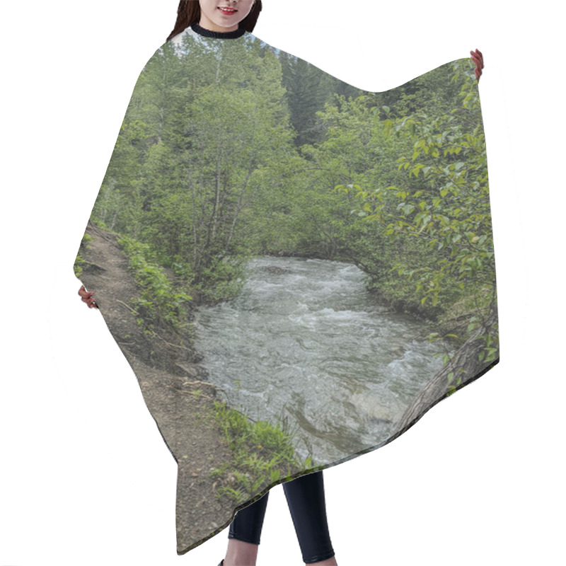 Personality  A Winding River Carves Through A Thick Forest With Lush Vegetation. The Rushing Water Follows A Natural Path, Flanked By Towering Trees And A Rugged Dirt Trail Along The Edge. Hair Cutting Cape