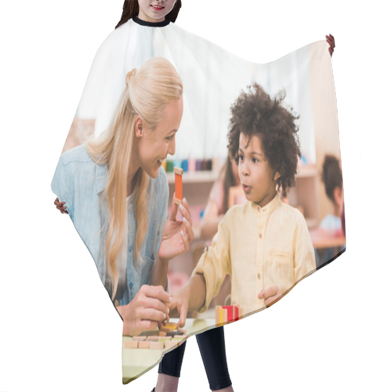 Personality  African American Child Playing Educational Game With Smiling Teacher In Montessori School Hair Cutting Cape