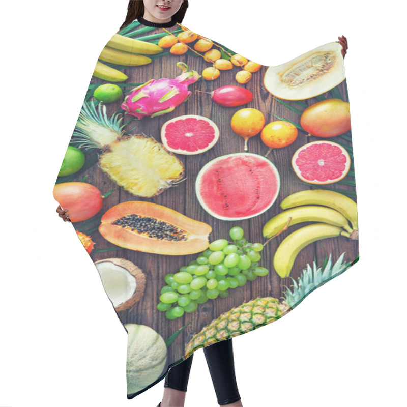 Personality  Assortment Of Tropical Fruits With Leaves Of Palm Trees And Exotic Plants On Dark Wooden Background. Top View Hair Cutting Cape