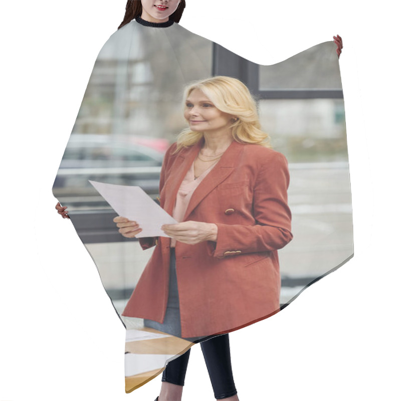 Personality  A Woman Stands At A Desk, Holding A Paper. Hair Cutting Cape