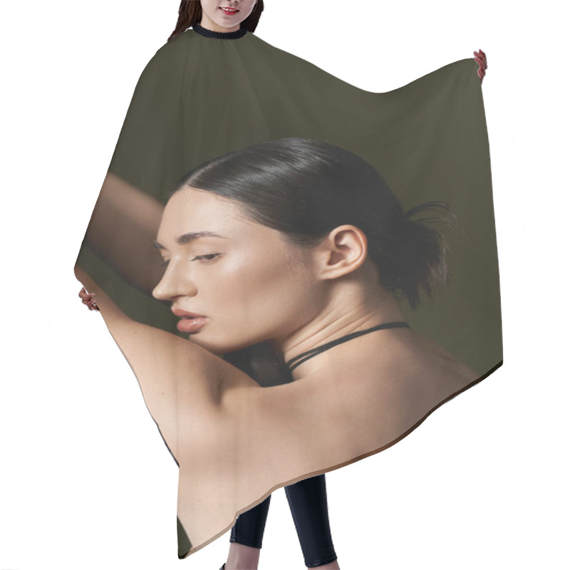 Personality  A Young Woman With Dark Brown Hair Poses Against A Black Backdrop Hair Cutting Cape