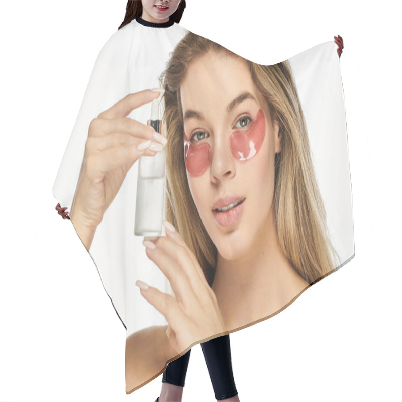 Personality  A Young Woman Showcases Her Skincare Routine, Holding A Serum While Wearing Eye Patches. Hair Cutting Cape