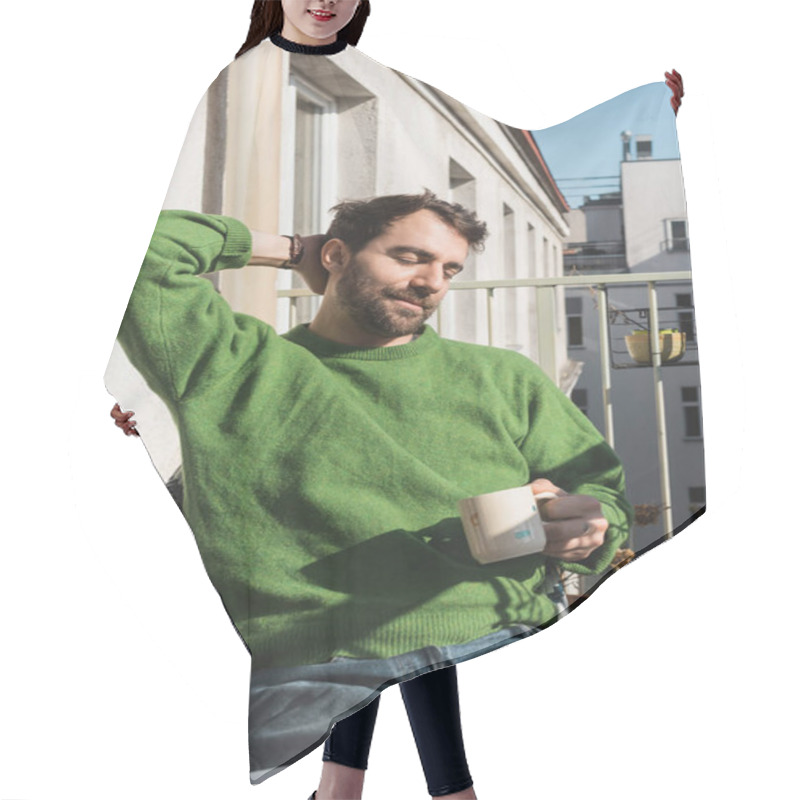 Personality  Relaxed Bearded Man With Closed Eyes In Green Pullover And Jeans Holding Cup Of Coffee In Morning Hair Cutting Cape