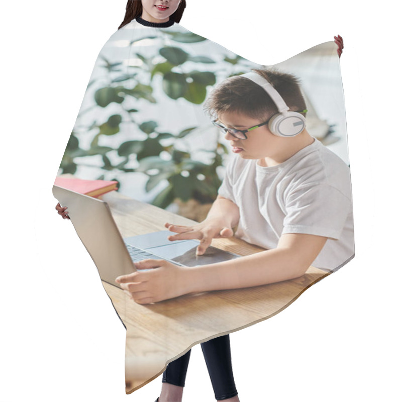 Personality  A Adorable Boy With Down Syndrome Wearing Headphones Is Engrossed In Using A Laptop At Home. Hair Cutting Cape