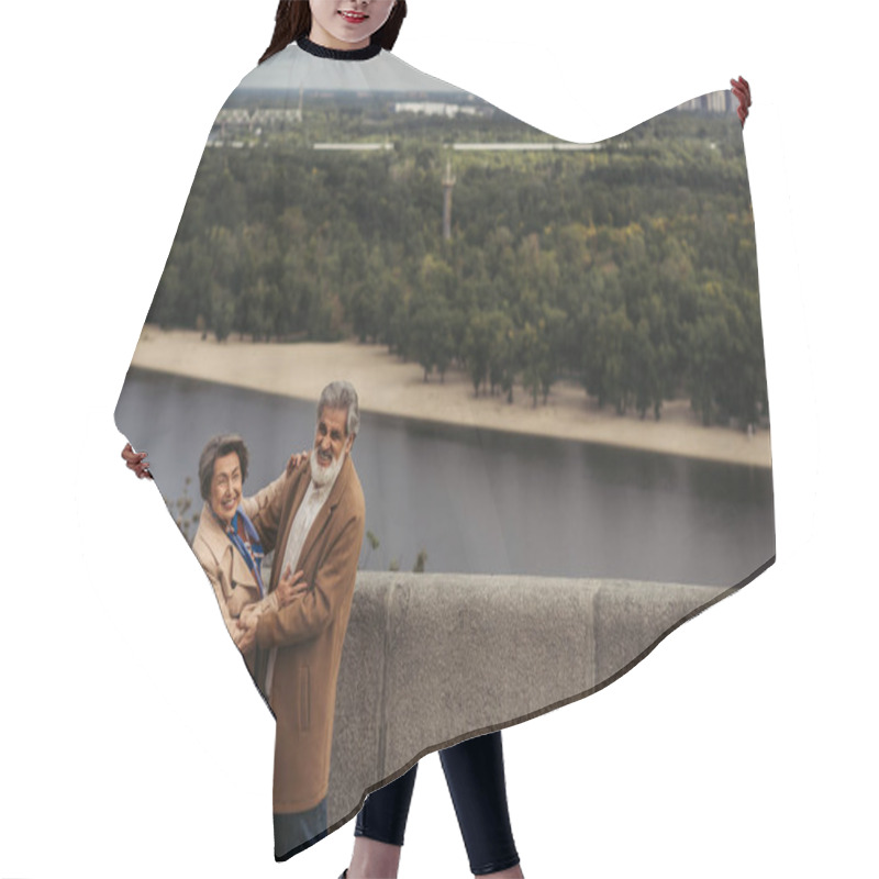 Personality  Cheerful Senior Couple In Beige Autumnal Coats Hugging On Bridge Near River  Hair Cutting Cape