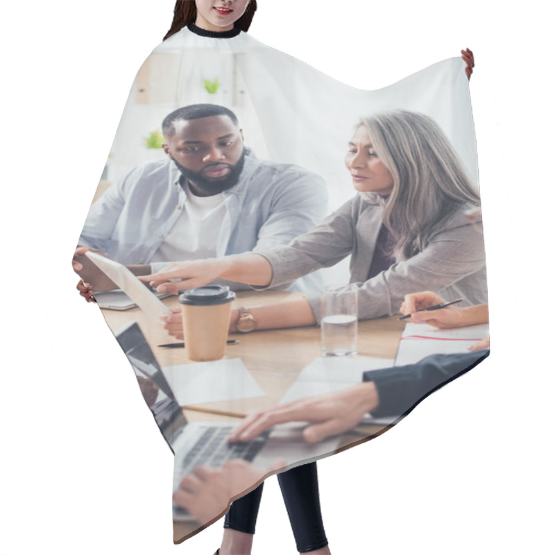 Personality  Selective Focus Of Asian Businesswoman Pointing With Finger An Digital Tablet And Talking With African American Colleague  Hair Cutting Cape