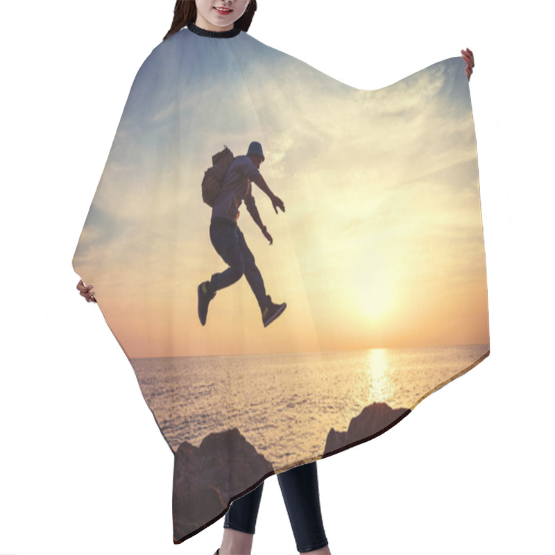 Personality  Brave Man With Backpack Jumping Over Rocks Near Ocean In Sunset Hair Cutting Cape