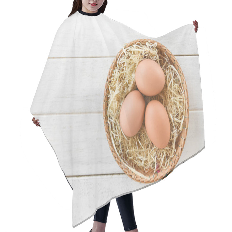 Personality  Chicken Eggs In Basket Nest On White Wooden Background  Hair Cutting Cape