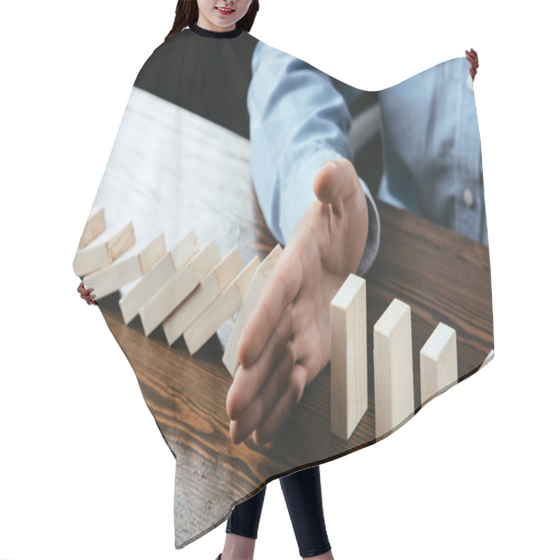 Personality  Cropped View Of Man Sitting At Desk And Preventing Wooden Blocks From Falling  Hair Cutting Cape