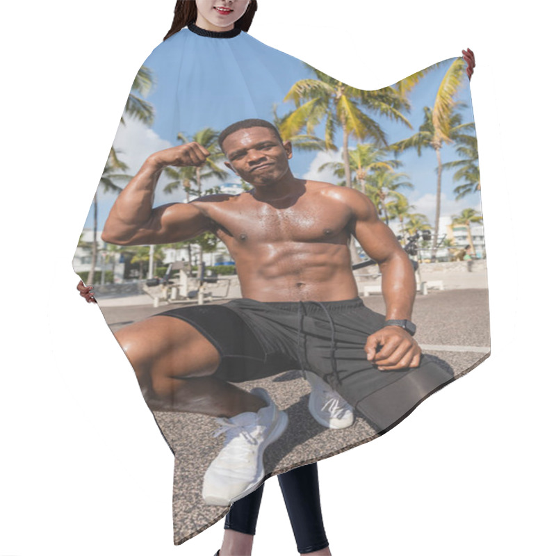 Personality  Strong African American Sportsman In Shorts And Sneakers Showing Muscles After Workout In Miami Beach  Hair Cutting Cape