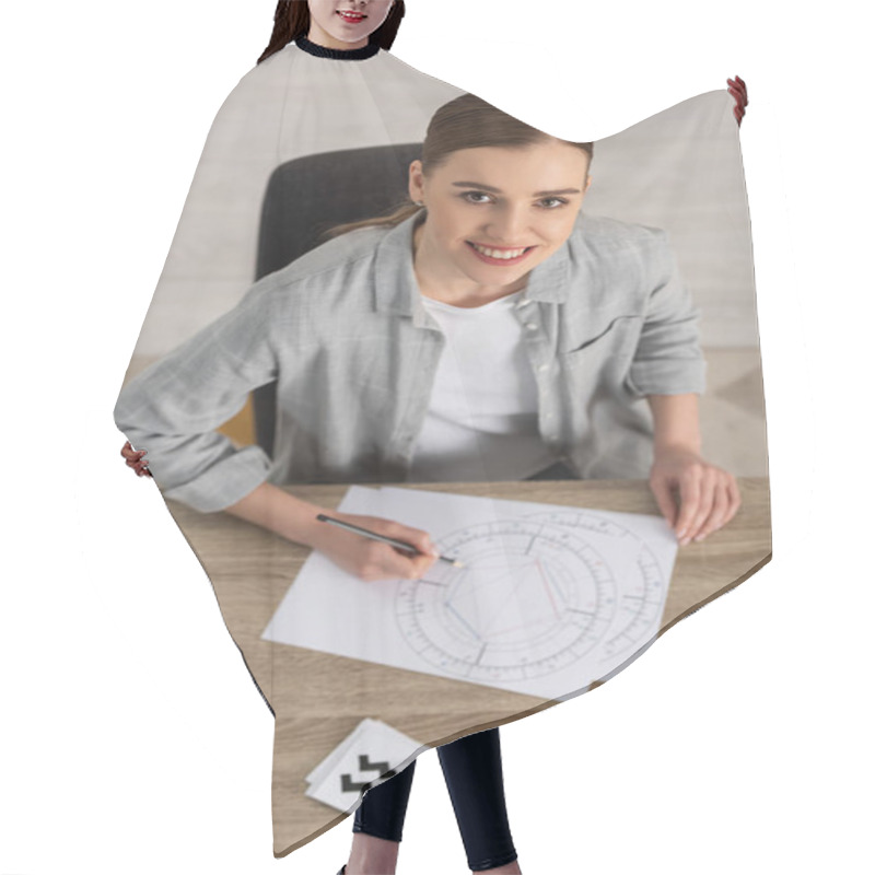 Personality  Beautiful Smiling Astrologer Drawing Natal Chart By Cards And Stones With Zodiac Signs On Table Hair Cutting Cape