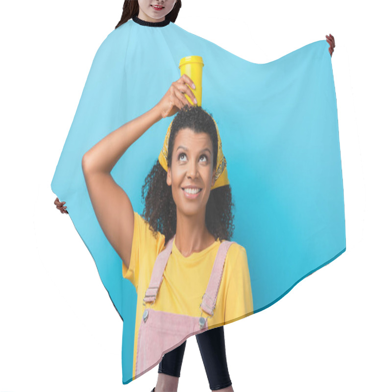 Personality  Happy African American Woman Holding Reusable Mug Above Head On Blue Hair Cutting Cape