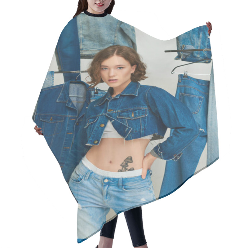 Personality  Pretty Girl In Cropped Jacket And Jeans Posing With Hand On Hip Among Trendy Denim Clothes On Grey Hair Cutting Cape