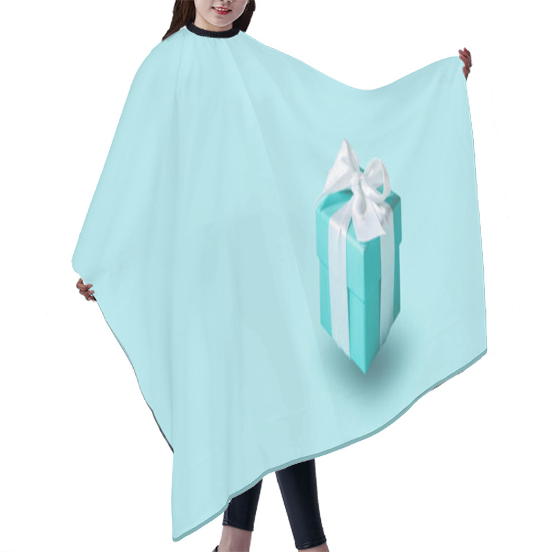 Personality  Flying In The Air The Gift Box Tied With Silk Ribbon On Tiffany Blue Color Pastel Background. Gift Festive Selection.   Hair Cutting Cape