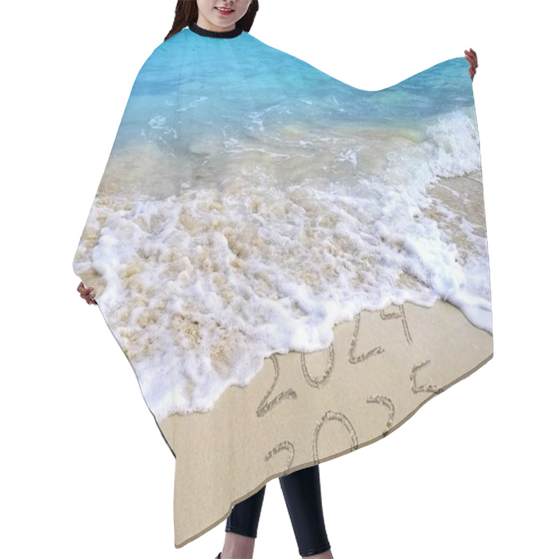 Personality  Waves Gently Wash Over 2024 Text Leaving 2025 Exposed In Beach Sand With Clear Blue Water In The Background Hair Cutting Cape