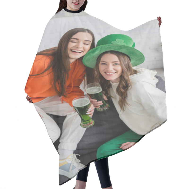 Personality  Positive Young Women Holding Green Beer During Saint Patrick Celebration At Home  Hair Cutting Cape