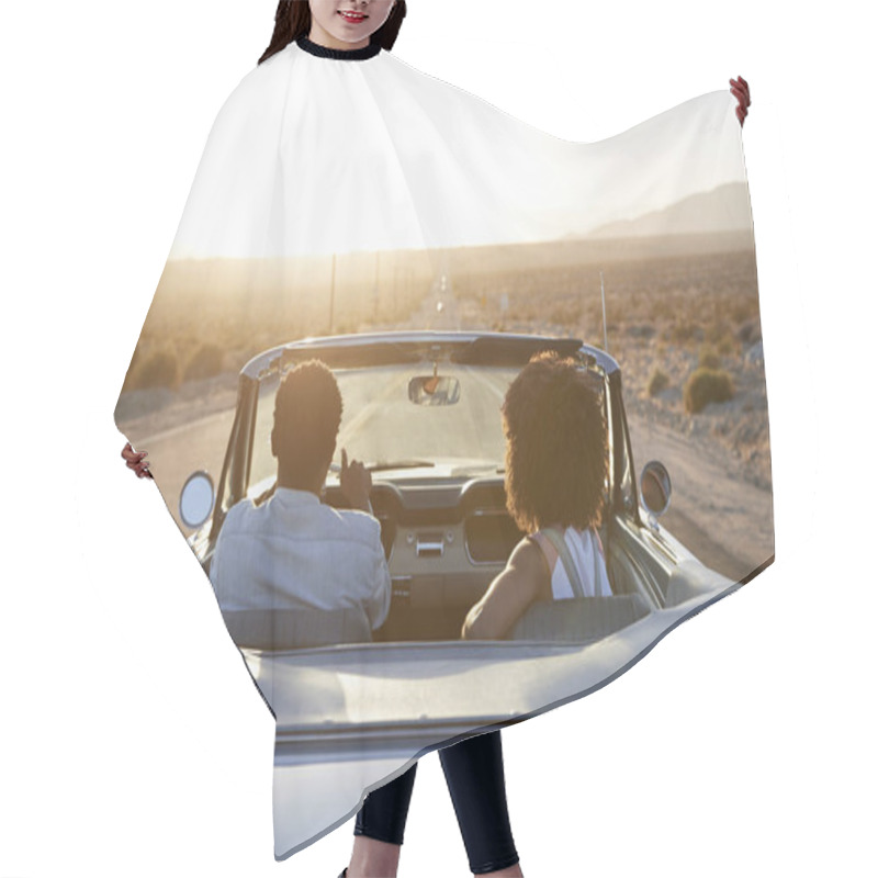 Personality  Rear View Of Couple On Road Trip Driving Classic Convertible Car Towards Sunset Hair Cutting Cape