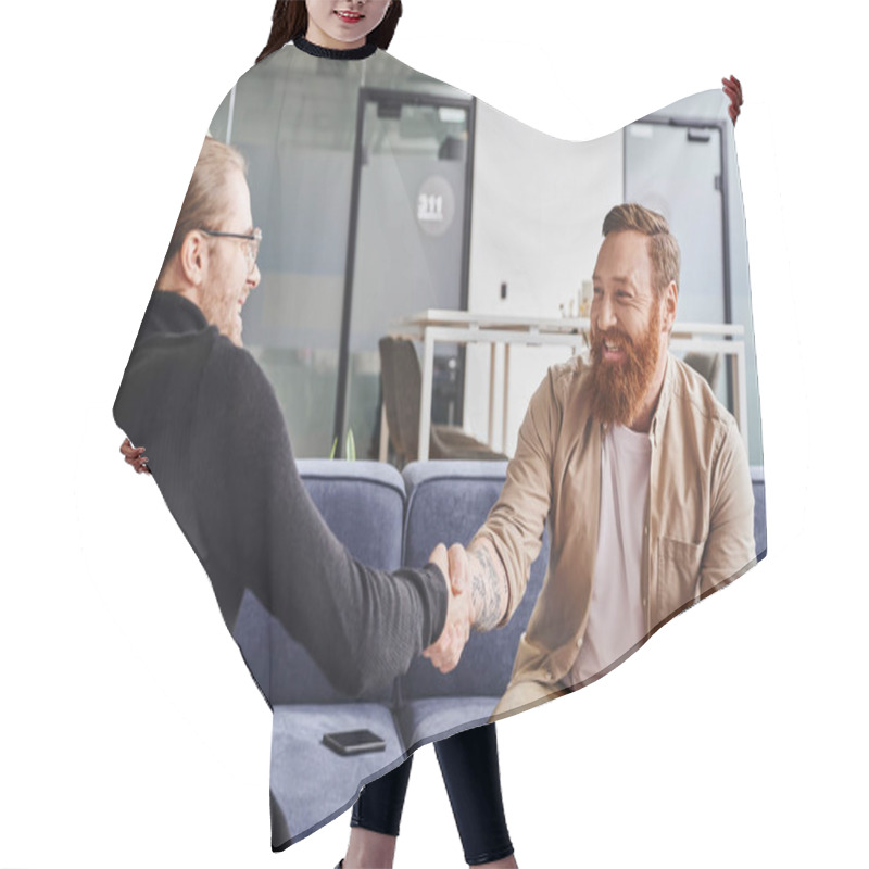 Personality  Delighted, Bearded And Tattooed Entrepreneur Sitting On Couch Near Smartphone And Shaking Hands With Business Partner In Black Turtleneck In Contemporary Office, Successful Partnership Concept Hair Cutting Cape