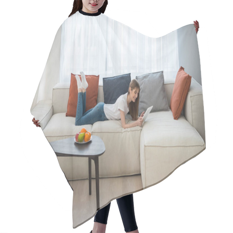 Personality  Side View Of Young Female Lying On Couch And Using Digital Tablet In Living Room With Modern Interior Hair Cutting Cape