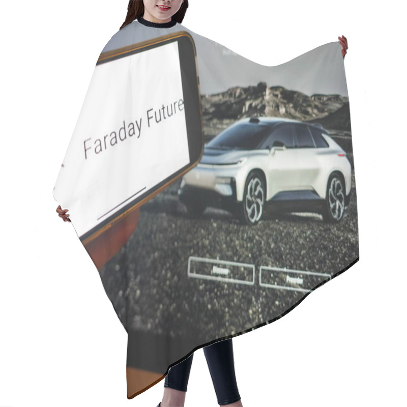 Personality  Roosendaal, The Netherlands - February 16, 2025:A Mobile Phone Displaying The Logo Of Faraday Future, With The Company Website In The Background. Hair Cutting Cape