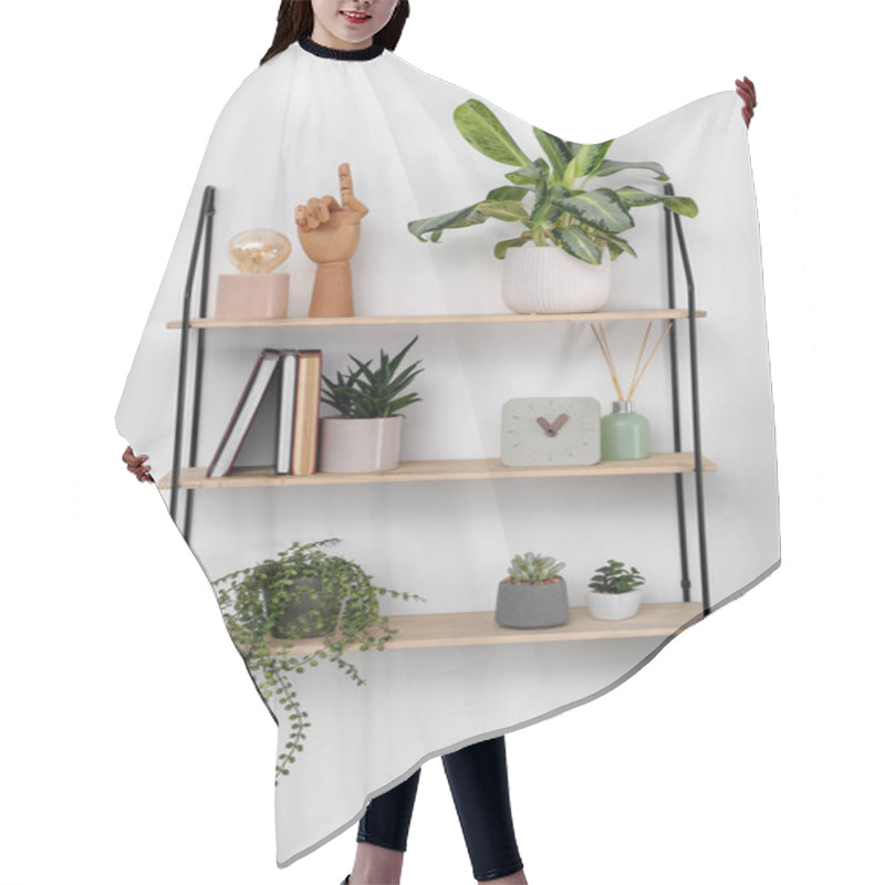 Personality  Shelving Unit With Beautiful Houseplants, Book And Decor On Light Wall Hair Cutting Cape