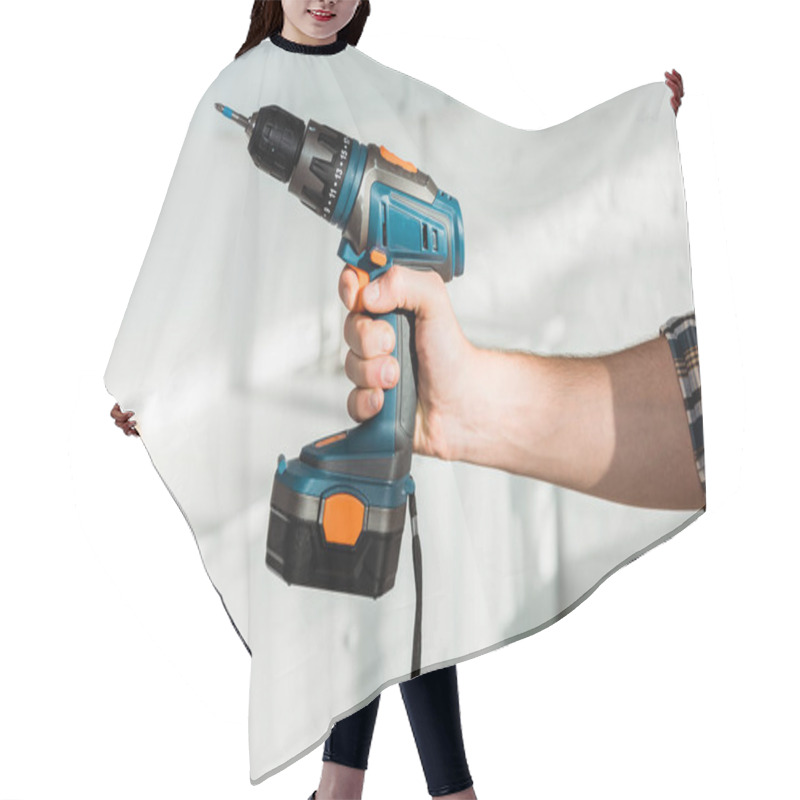 Personality  Cropped View Of Installer Holding Hammer Drill In Hand  Hair Cutting Cape