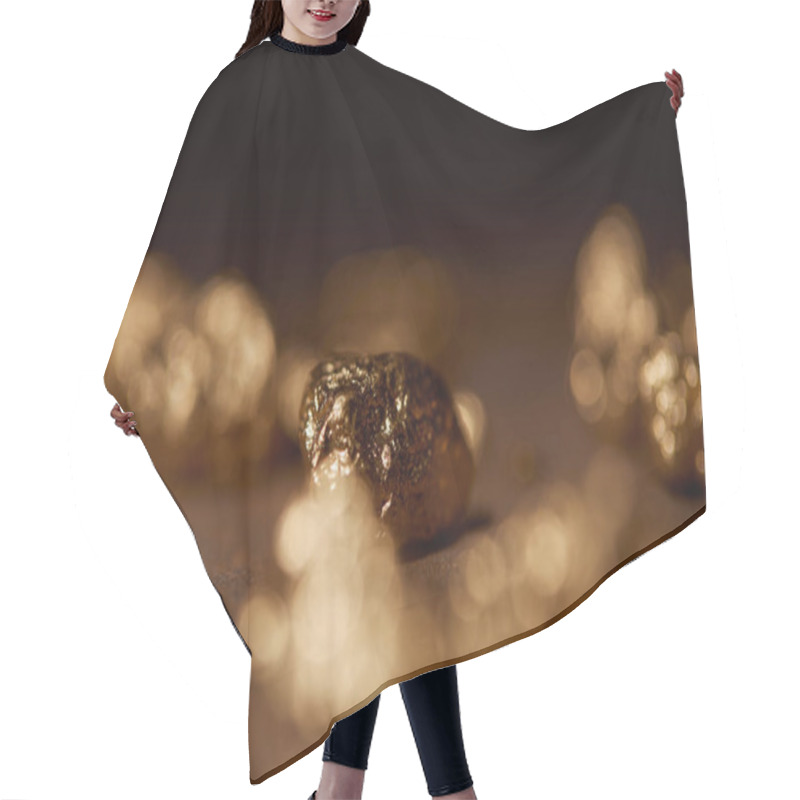 Personality  Selective Focus Of Golden Stone On Blurred Dark Background Hair Cutting Cape