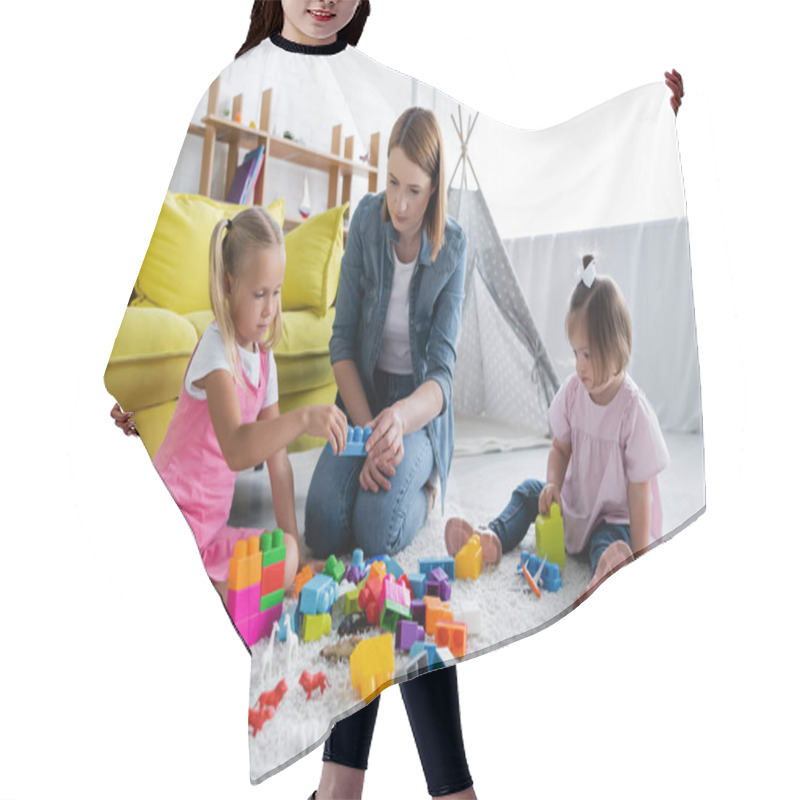 Personality  Kindergarten Teacher Playing Building Blocks With Preschooler Girl And Toddler Kid With Down Syndrome  Hair Cutting Cape