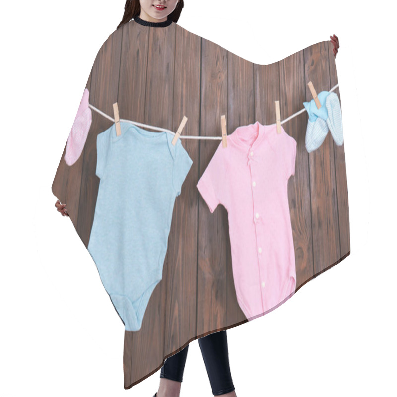 Personality  Children's Clothes On Laundry Line Against Wooden Background Hair Cutting Cape