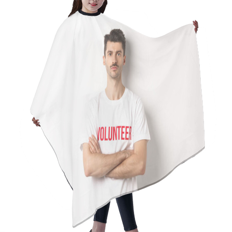 Personality  Serious Young Male Volunteer In White T-shirt, Holding Arms Crossed On Chest, Looking At Camera, Ready To Help Hair Cutting Cape