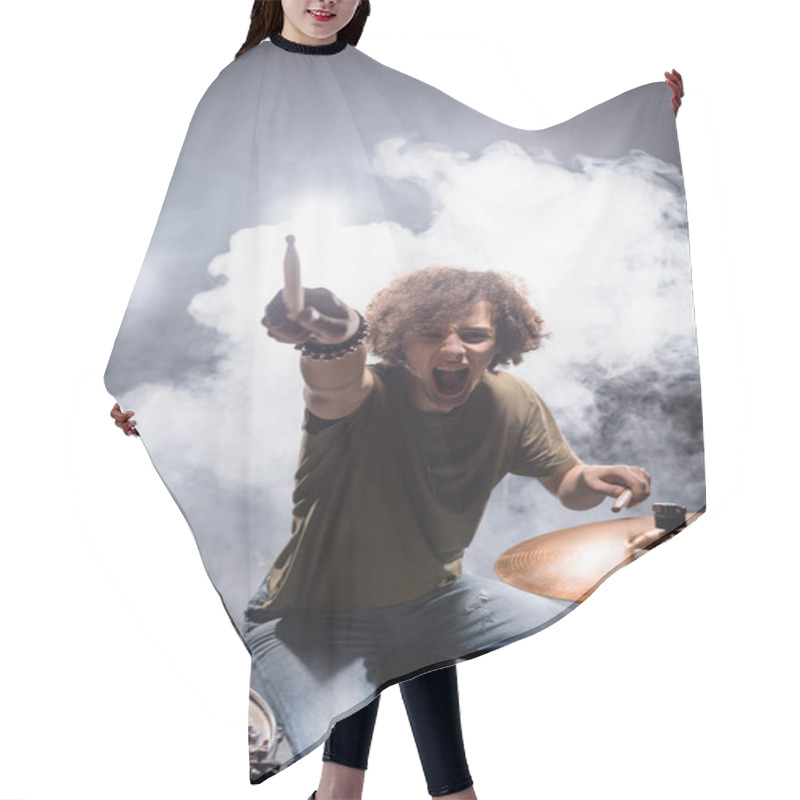 Personality  Curly Drummer Pointing With Drumstick While Shouting And Sitting At Drum Kit With Smoke On Background Hair Cutting Cape