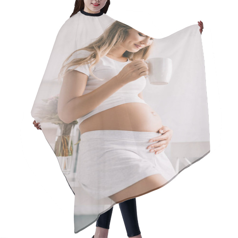 Personality  Smiling Pregnant Woman With Cup Of Tea In Hand Touching Belly At Home Hair Cutting Cape