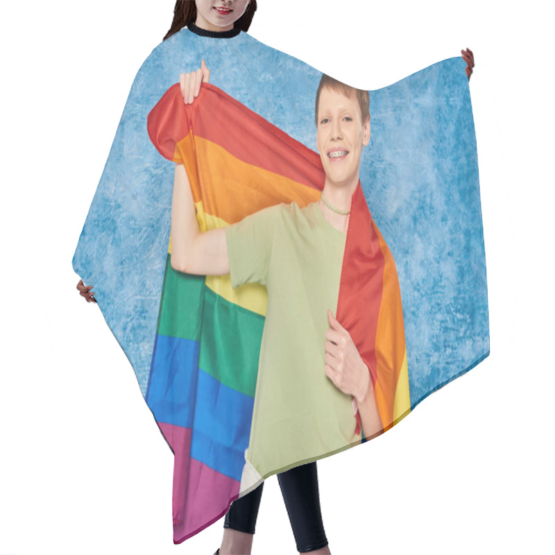 Personality  Cheerful Gay Man In Casual Clothes Smiling And Holding Lgbt Flag And Looking At Camera During Pride Month Celebration On Mottled Blue Background Hair Cutting Cape