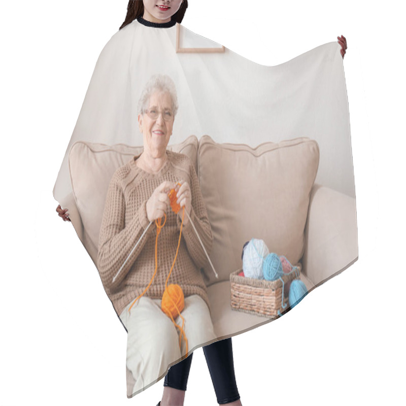 Personality  Senior Woman Sitting On Sofa While Knitting Sweater At Home Hair Cutting Cape