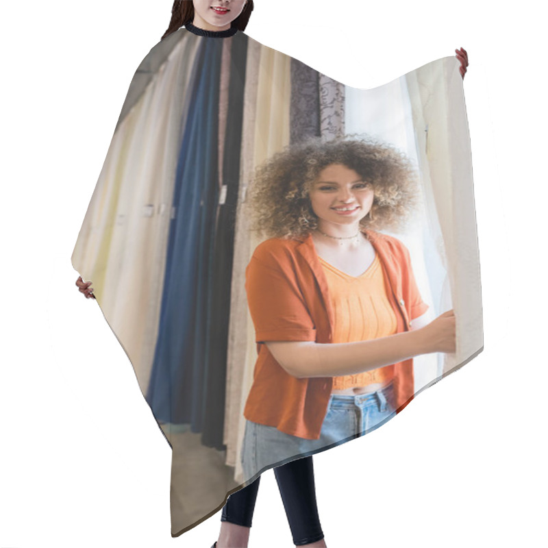 Personality  Pretty And Curly Woman Looking At Camera Near Various Curtains In Textile Shop Hair Cutting Cape