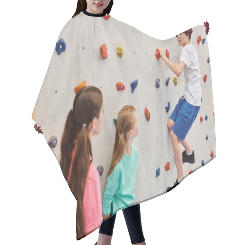 Personality  A Group Of Young Children Stand Together In Front Of A Climbing Wall, Listening Attentively To Their Teachers Instructions Before Attempting To Scale The Wall. Hair Cutting Cape