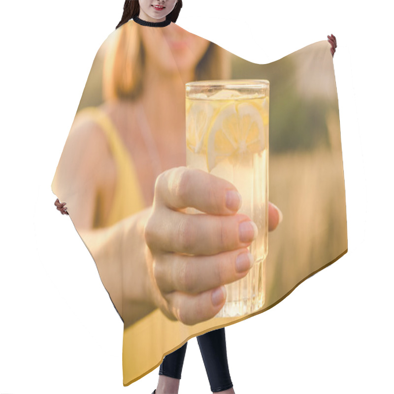 Personality  Lemonad Yellow Nutritional In The Hand Of A Young Girl In A Yellow Sports Shirt On Blurred Background Nature Hair Cutting Cape