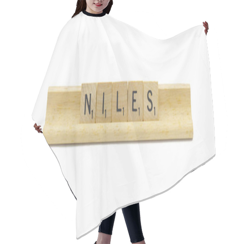 Personality  Miami, FL 4-18-24 Popular Baby Boy First Name Of NILES Made With Square Wooden Tile English Alphabet Letters With Natural Color And Grain On A Wood Rack Holder Isolated On White Background Hair Cutting Cape