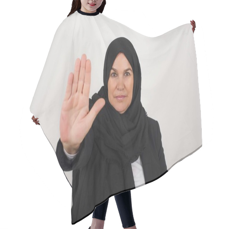 Personality  Young Muslim Woman In Black Hijab  Doing Stop Gesture With Palm Of The Hand. Warning Expression With Negative And Serious Gesture On The Face Isolated Over Gray Background. Hair Cutting Cape