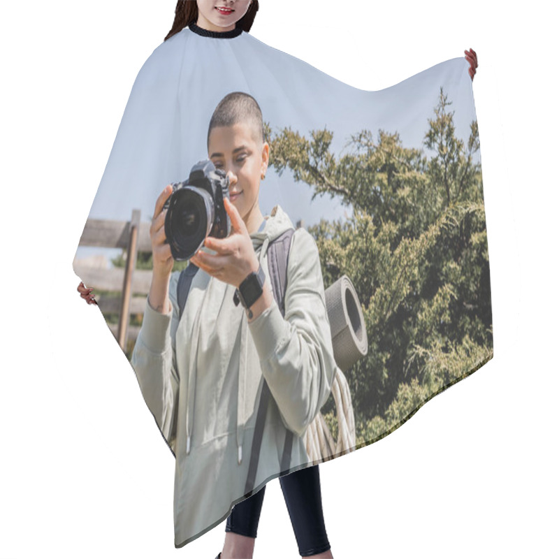 Personality  Positive Young Short Haired And Tattooed Woman Tourist With Backpack Taking Photo On Digital Camera While Standing With Nature And Blue Sky At Background, Hiker Finding Inspiration In Nature Hair Cutting Cape