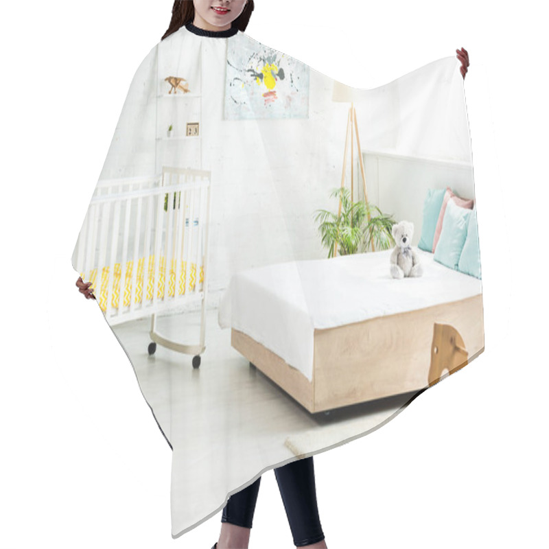 Personality  Baby Crib Near Bed With White Bedding And Pillows Near Teddy Bear And Rocking Horse  Hair Cutting Cape