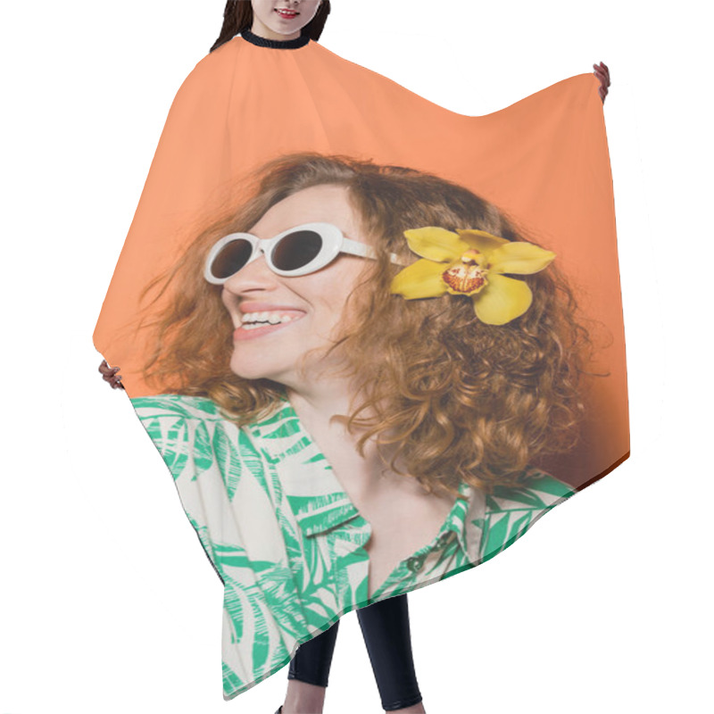 Personality  Happy And Confident Young Redhead Woman With Orchid Flower In Hair, Stylish Sunglasses And Modern Blouse Standing On Orange Background, Summer Casual And Fashion Concept, Youth Culture Hair Cutting Cape